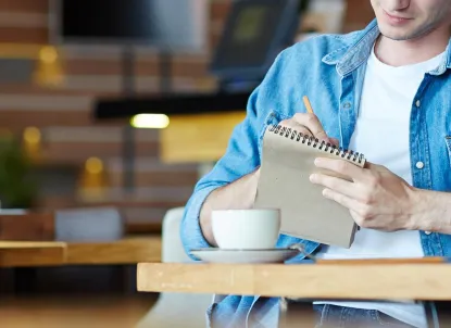 Young man taking notes