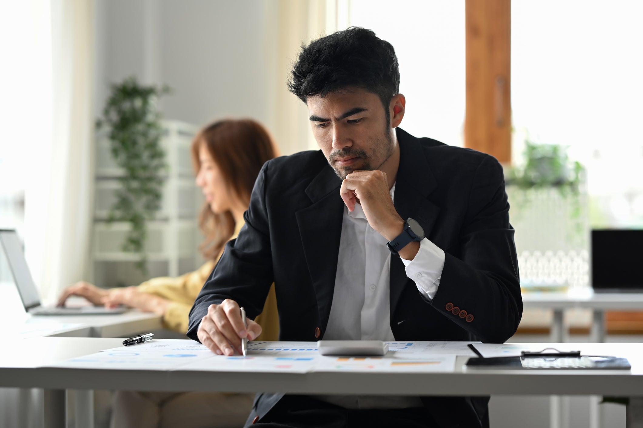 business man at desk reviewing business plan