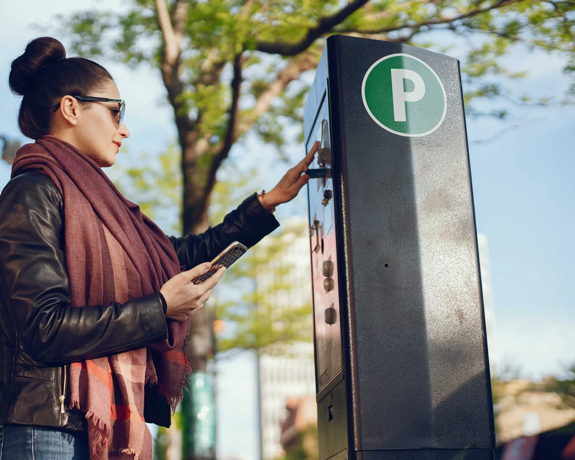 Young woman paying for parking