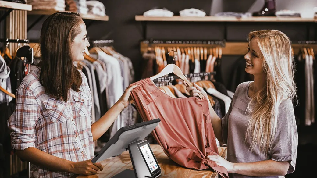 Woman making a purchase in a retail clothing shop