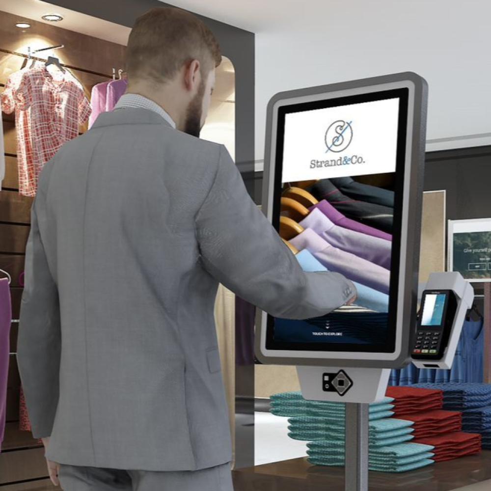 man using a self service kiosk to browse more shopping items