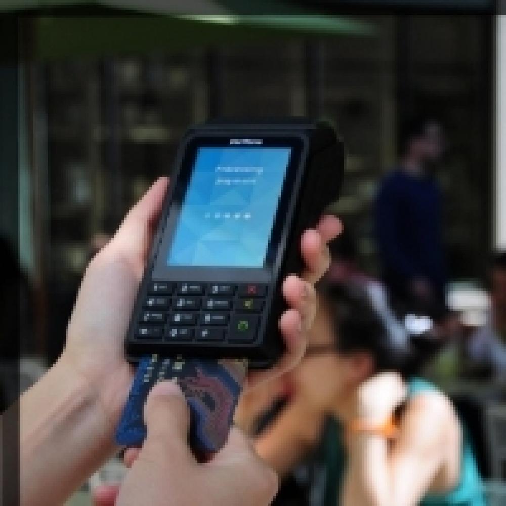 Portable payment device being used in a cafe