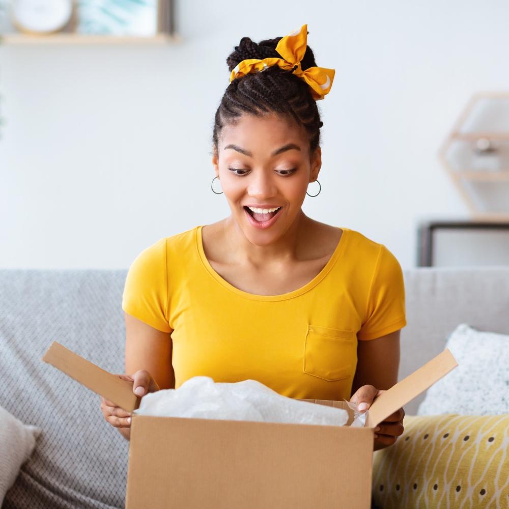 surprised Girl opening a box