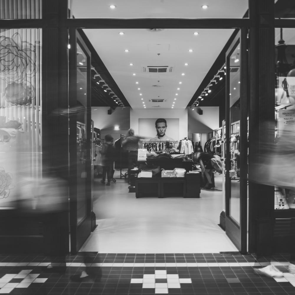 black and white photo inside a european fashion store