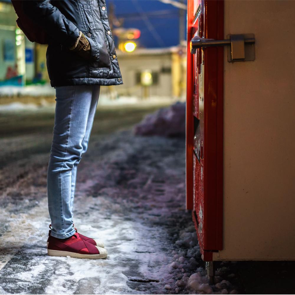 man paying in front of a vending machine